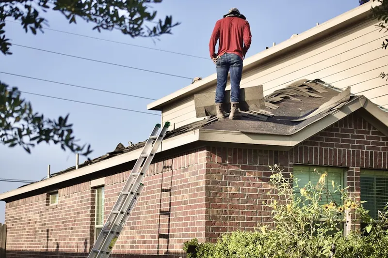 Professional roofer working on a residential roof in Delphos